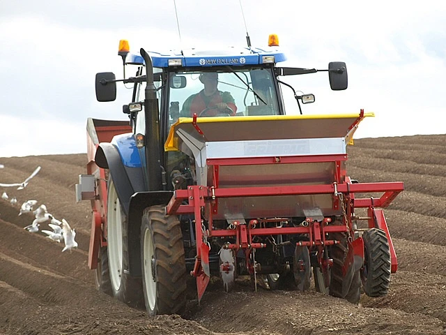 Een tractor poot aardappelen op een groot veld in de VS - Wikipedia